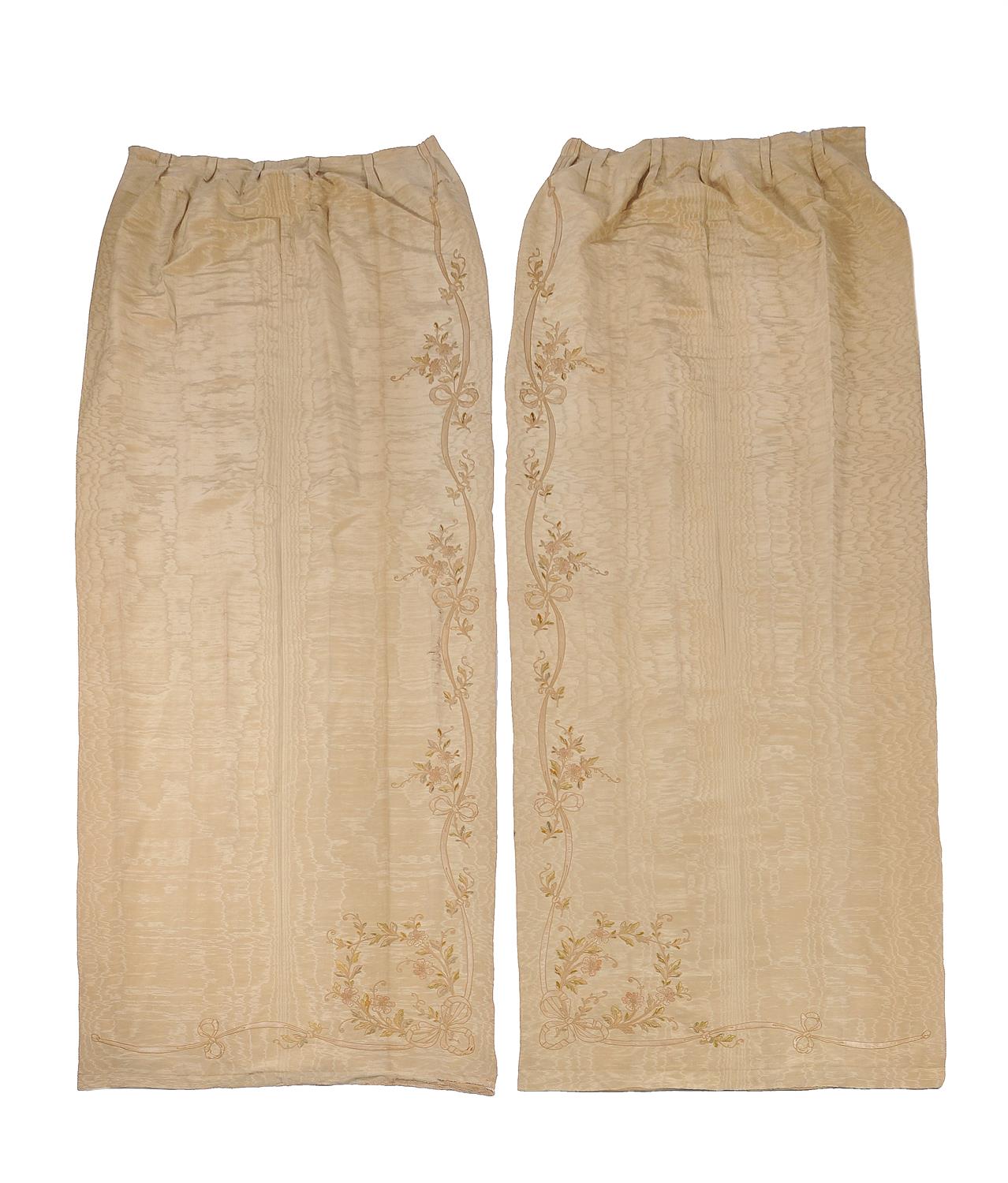 A pair of late 19th/early 20th century moiré silk and floral embroidered panels, possibly entre fenetres, each of pale sand-brown colour, each approximately 291cms high, 120cms wide at the ground (2).